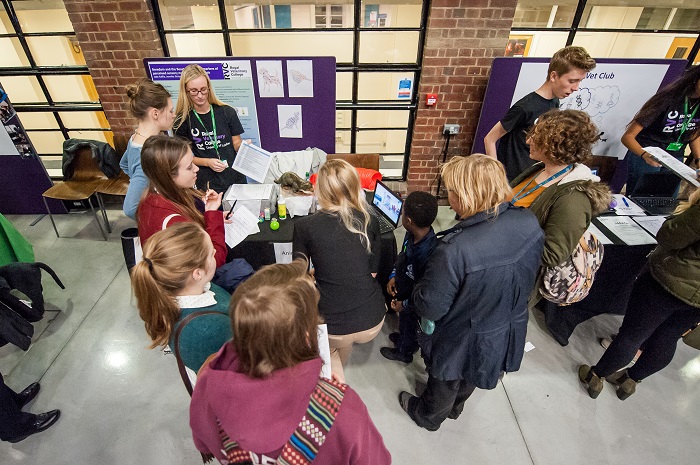 A busy event stand of people learning about boredom in animals