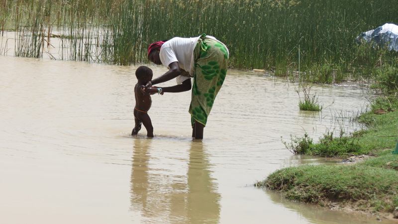 Young child being bathed in river